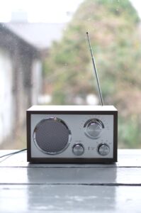 small retro radio set on wooden windowsill